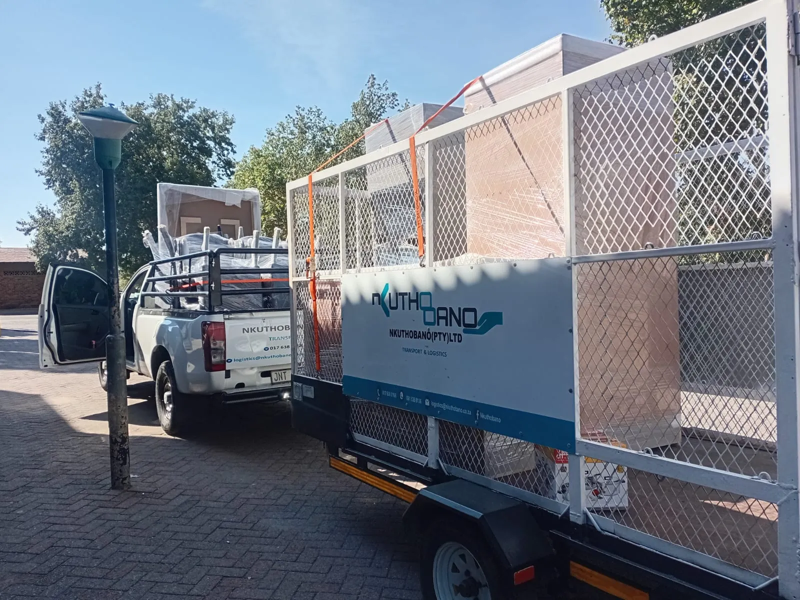 Nkuthobano branded transport vehicles carrying secured delivery loads